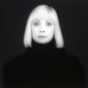 Portrait of Doris Saatchi wearing a black turtleneck, looking straight into camera.
