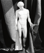 Sculpture of Antinous against a curtain background