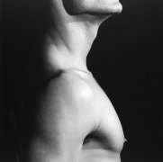 Profile view of man from chest to chin.