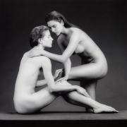 Sonia and Tracy, both nude, facing each other and touching.