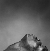 Black male portrait in profile, head facing up.