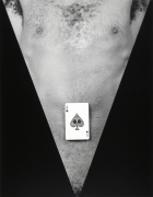 Jack Walls, only chest/torso visible, with a single playing card on his stomach.