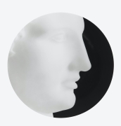 Circular plate with a close up photograph of a sculpture of Ermes against a black background.