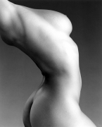 Nude woman's chest and torso twisting.