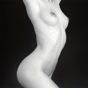 Nude woman's chest and torso twisting.