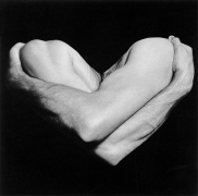 Two arms in shadow forming the shape of a heart.