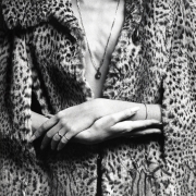 Jennifer Jakobson wearing leopard coat, with manicured hands held in center.