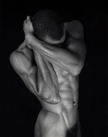Black Male nude covering his face.