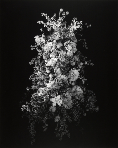 Large bouquet of flowers of varying types against black background.