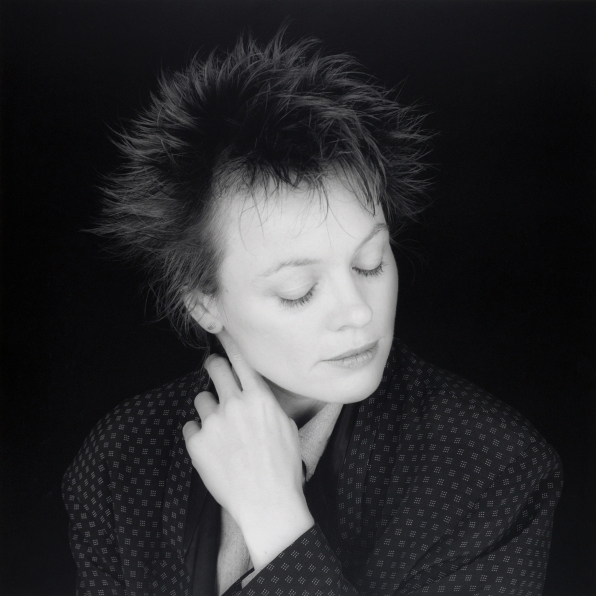 Portrait of Laurie Anderson looking down.