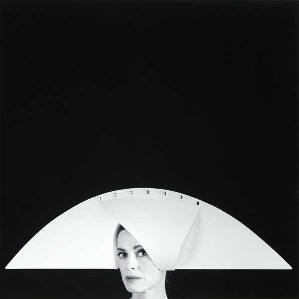 Portrait of Lucinda Childs in a geometric hat.