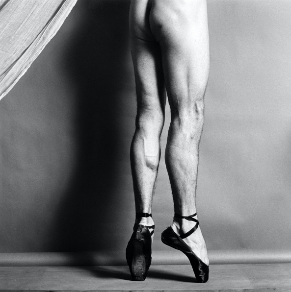 Dancer from the waist down, naked  except for pointe shoes, facing away from camera.