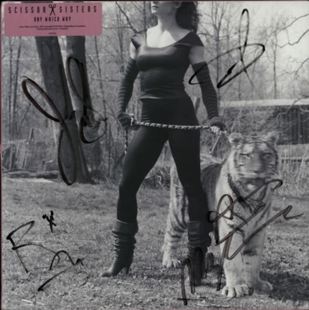 Album cover for the Scissor Sisters  Any Which Way featuring Lisa Lyon standing with a tiger on a leash.