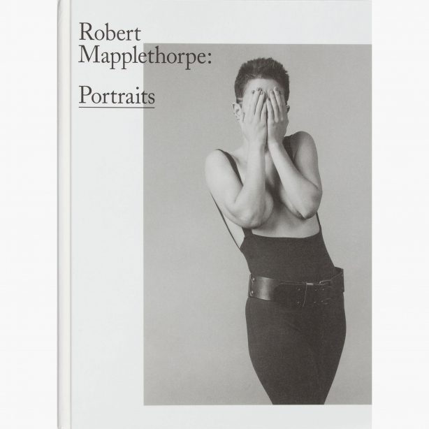 Portrait of Kathy Acker covering her face with her hands.
