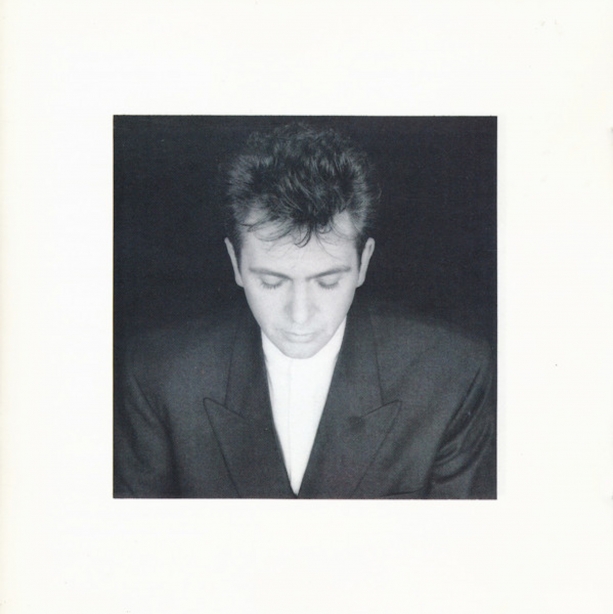 Peter Gabriel Album cover, portrait of Peter Gabriel wearing a suit, looking down with eyes closed, image is framed with a thick white border.